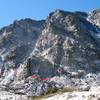 Directly below arete, just above lake. From other pictures, I think the standard start is up the middle slab. The stab to its right is harder and described as direct. There may be a variation up the gully and slab to the left.