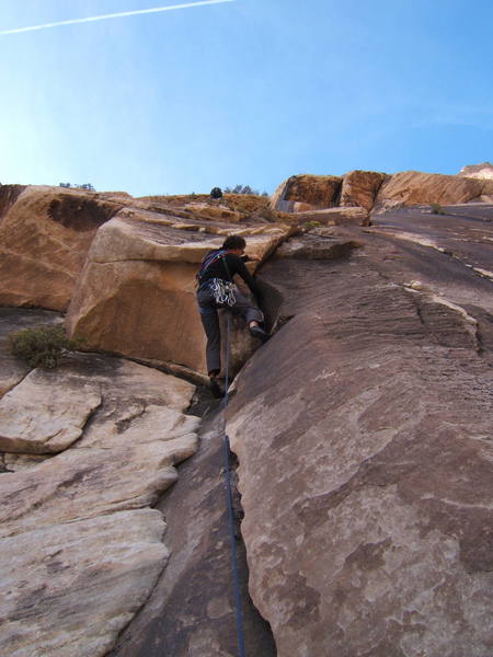 Timmy pulling through the small roof on pitch 3.