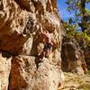 Erik Wolfe getting established on Carmel Coated Fun with Deidre belaying.