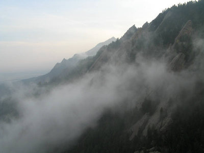 Climbing through the clouds as seen from the Standard East Face on the Third Flatiron.
