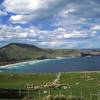 The Otago Penninsula protects Dunedin from rough weather from Antarctica.  In 2006, several gigantic icebergs broke off from Antarctica and floated right past this spot.