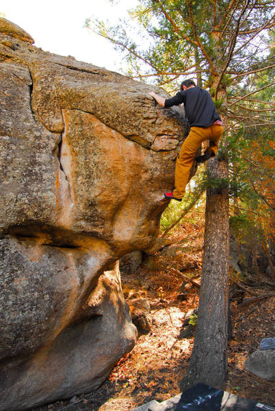 Chris pulling over the crux on the Nine Lives Boulder.<br>
<br>
Photo by Andy. 