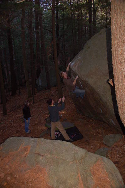 Sam Todzia taking a run up this climb while I spot and Kristin looks on.