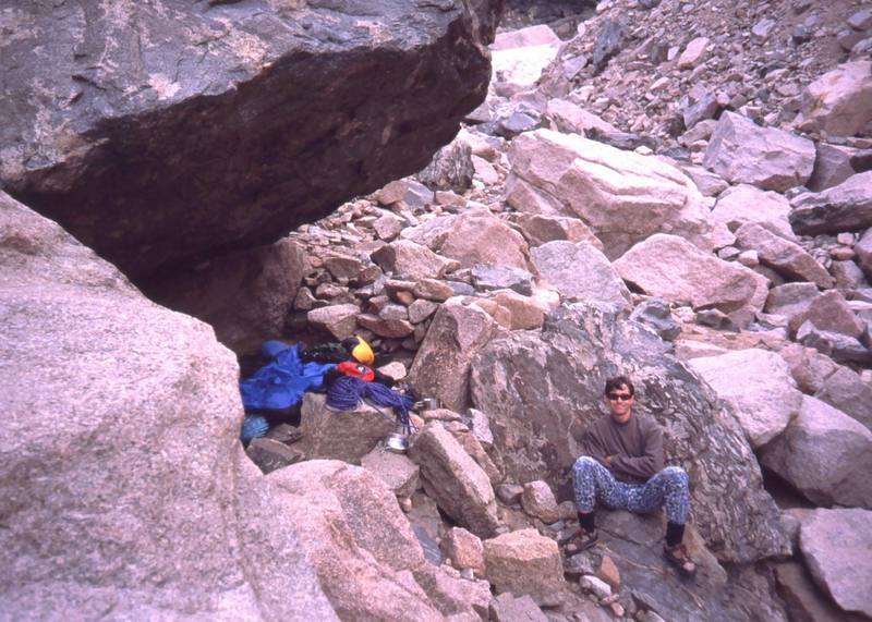 A typical bivy in RMNP. Find a good overhanging rock and hope it stays dry. This one is up above Chasm Lake and is good for hitting the Diamond via Alexander's Chimney. Photo by Joseffa Meir, 2001.