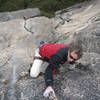 Gerry Jesserun "pulls a tendon" on the back side of the "fist" feature of 'Power To The People' (5.9R), Shuteye Ridge. This photo is also within the Shuteye Ridge guidebook, under the Lost Eagle section.