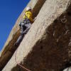 Moving past the first bolt to the second and last bolt, also a quarter incher. These is the second and harder crux. Greg has a bunch of trad gear, because it's a long way on easier trad ground to the belay.