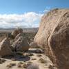 Looking west from the So High Boulder (foreground) with the Wave and Wedge Boulders (l-r) in the distance, Joshua Tree NP