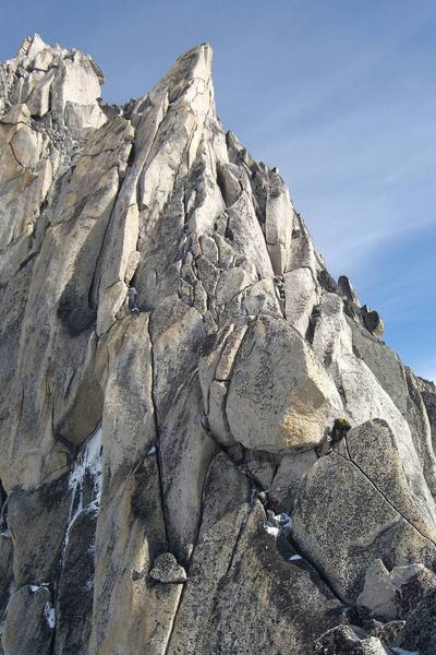 Approaching the gendarme on the Kain route. Climber is in the lower right of the photo. The summit of Bugaboo is in the upper left of the photo.