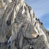 Approaching the gendarme on the Kain route. Climber is in the lower right of the photo. The summit of Bugaboo is in the upper left of the photo.