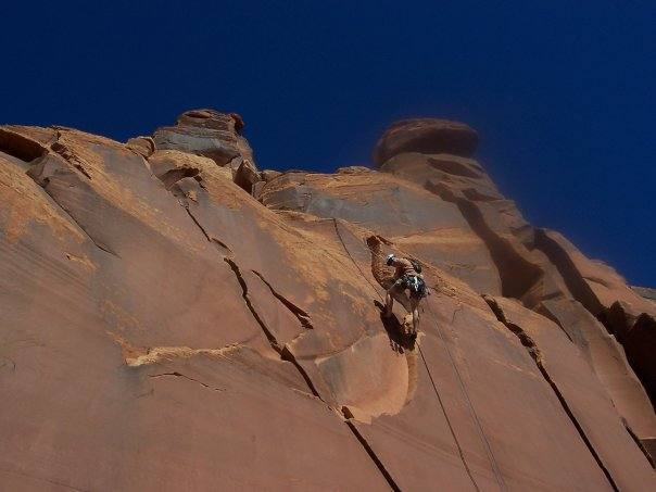 The left-arching crack to Jason's left is 5.10b.  Other variations exist to his right (5.9).