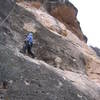 In the crux of "Violence", 5.10d (route #13 on the topo).  The route "Upper Crack" (#11) climbs through the roof crack in the top of the photo.