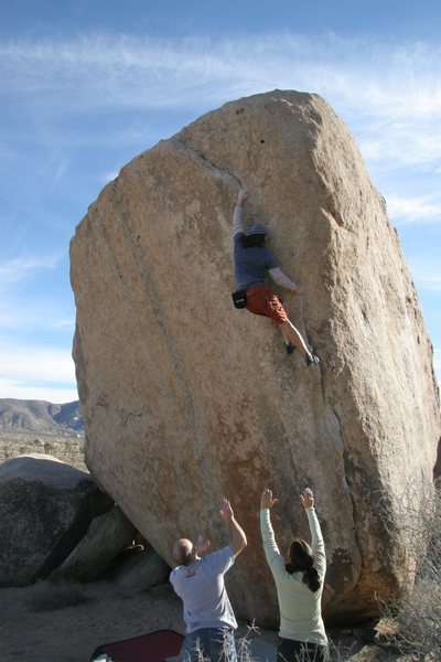 Making the crux span on White Rastafarian, V3