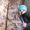 Bolt at 4th pitch anchor with perfect rock and cracks next to it.