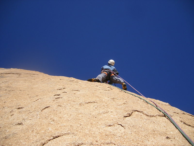 Looking for the first bolt on the run-out pitch to the summit.