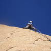 Looking for the first bolt on the run-out pitch to the summit.