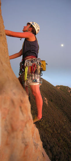 Laura stepping out of the cave at the first (or second) belay.