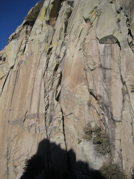 Pitch 1 climbs the chimney/crack system in the middle of the photo