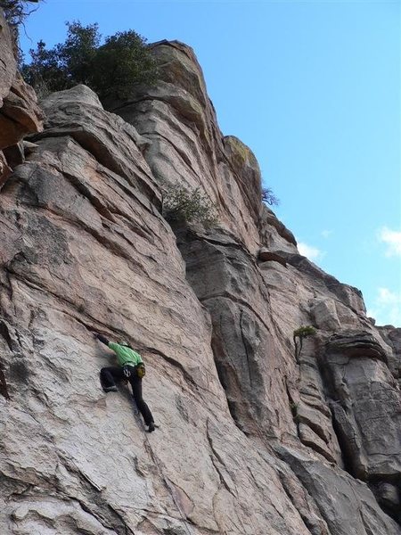 climber on TBA (5.9). A River Runs To It is the route to the right which goes up the black arete/face and then all the way to the top