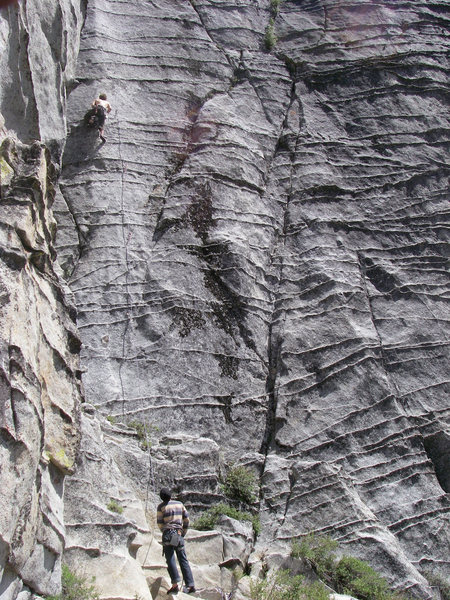 Bucket Guy looks on as Gregory Turner eyeballs the crux of Power Lust 5.11