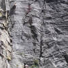 Bucket Guy looks on as Gregory Turner eyeballs the crux of Power Lust 5.11