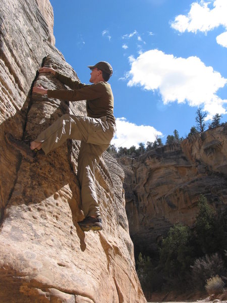 Kevo scrambling on some good stone, somewhere in Escalante.