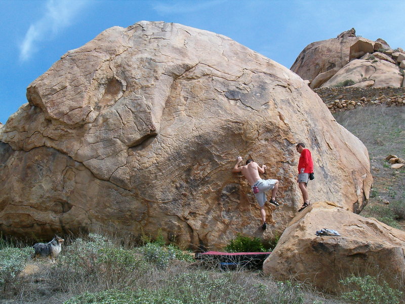 "Cherry Dip Scoop" on the northwest face of the Harrison Boulder. "Thumbelina" can be seen 15 feet to the left. (photo by Chris Miller)