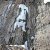 Kate Muehling hopping onto the ice on Chimney. March '08. Photo by Henning Boldt.