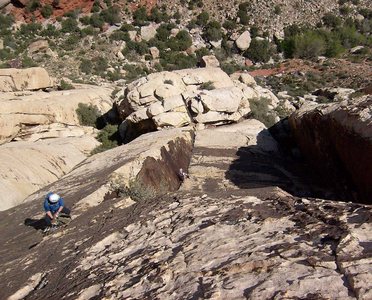 Looking down the varnished corner of pitch 4.  The belay at the top of pitch 4 is on the left.  This picture was taken from near the beginning of the fifth pitch, above the large overhang.