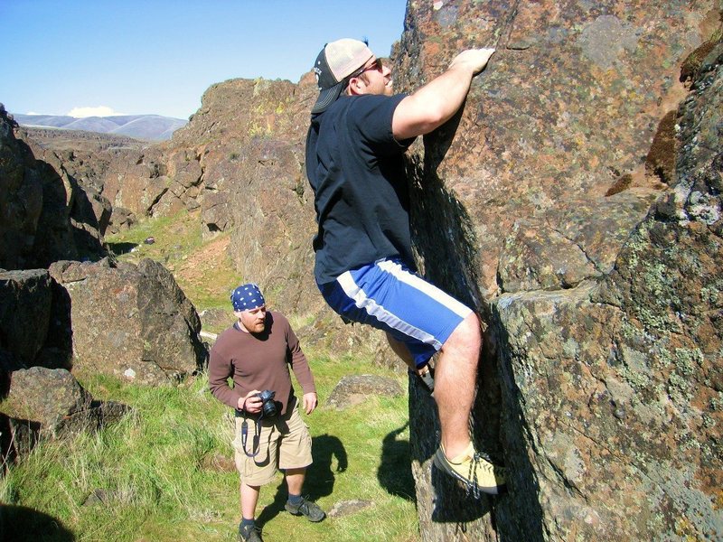 There are 3 problems on this short boulder. One in the middle with a sit start. Goes up and left, V1ish. One that starts on the left corner goes straight up, V0/+. The other starts with matched hands on the ledge right in front of his knee and goes right and traverses slopers all the way to the right, V1+ or so. I don't know if any of these ratings are accurate, we just cleaned them off and I don't know is anybody else has done these. If somebody does them I'd like to know what they feel they are like.