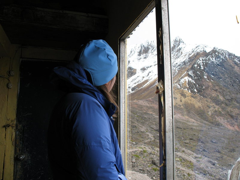 Nancy Bell looks toward the summit from inside the refugio as the day draws to a close, hoping for a successful ascent in the morning.