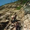 Hank bat hooking and drilling on the crux pitch.  