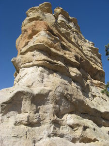 West end of the south side.  This is the "route".  A fixed piece of (rotten) webbing and ancient carabiner visible in the dark band of rock on the right.