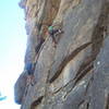 Jimbo trying to find footholds on Slip Service the old fashioned way.  Nancy Brass in green is climbing the other new route Jimbo alleges to have put up.