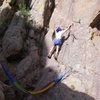 Dave stepping up to the first bolt above the belay/hammock.