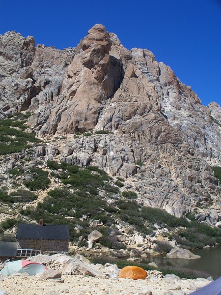 Aguja Frey rising behind Refugio Frey.  The route is the big crack right in the center.