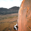 The crux of Learning To Crawl (5.11c) Indian Creek, UT.  Somehow this beta works for me.  Photo by Charles Vernon.