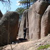 THE CORRIDOR-<br>
Gargoyle rock to the left, with the arete in shadow. The Crack Traverse to the right on right wall. Ken standing beneath a .10+ crack.