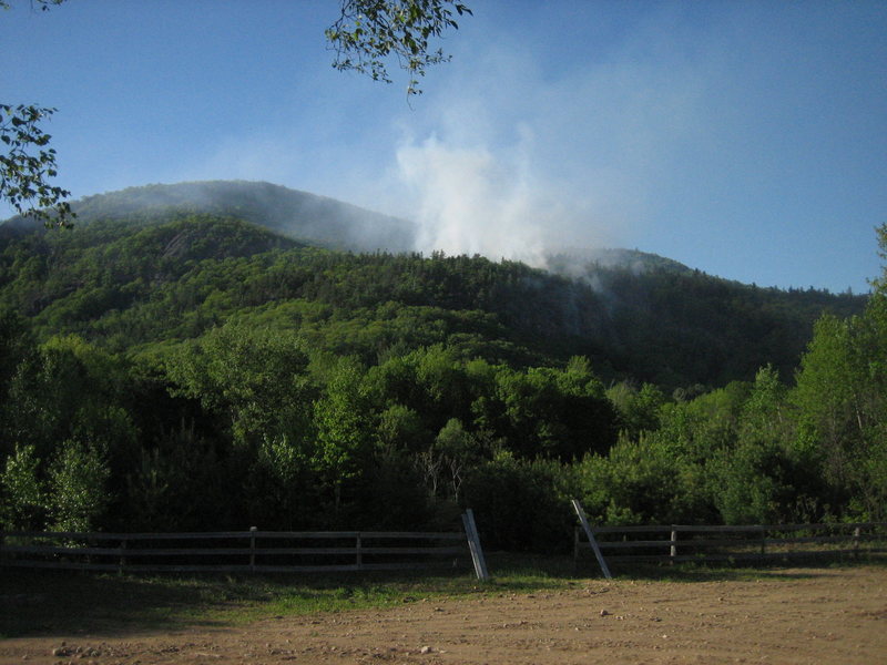 Rumney forest fire, May 28th. Main Cliff is visible underneath the smoke. The big slab on Jimmy Cliff can be seen to the left. 