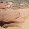 A giant pothole on the summit of Monitor Butte... Aeolian and Echo can be seen in the distance across Courthouse Pasture.