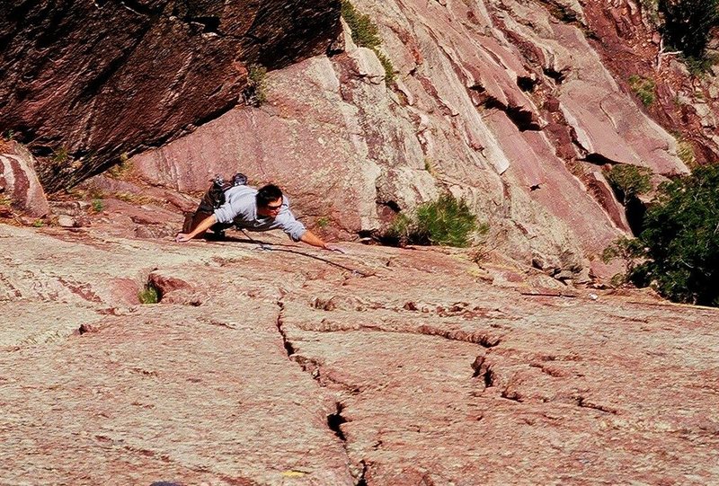 Jason Haas sets up for the reachy crux of 'The Throne' (11b/c) on Shirt Tail Peak in Eldo. Photo by Tony Bubb, 5/08.