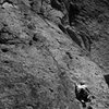 Sarah on lead reaching for another great big golf-ball knob, 3/4 of the way up Dancer, 5.7, Smith Rock. 