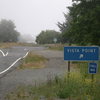 The vista point parking area for Footsteps Rock. Located around Hwy 101 milepost 13.44. Although you can squeeze off the road right at the trail, parking in the vista point gets your vehicle a little off the highway.