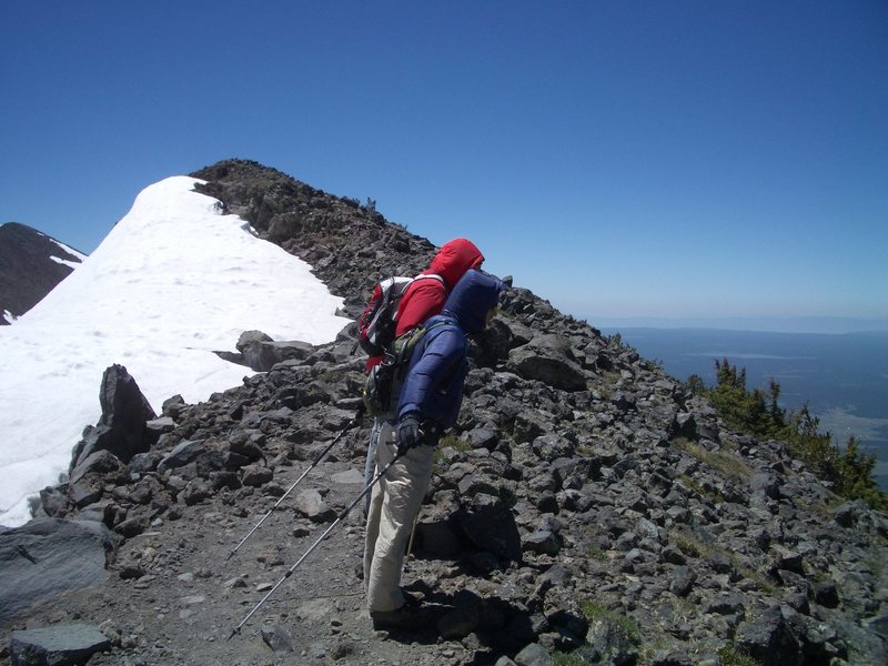 Leaning into the wind below the summit.  The gusts will take you off your feet!  Careful...