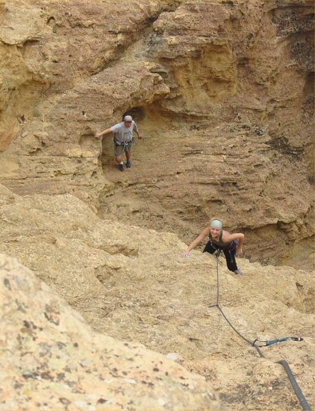 Carrie following the bolted face pitch (#2) with Mark waiting his turn just outside of the western opening of the cave.