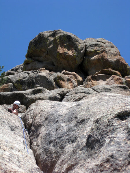 Mark belaying at the top of the 4th pitch and laughing as hard as I am at the giant stone butt on top of the route. 