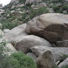 Behind the green bush is the entrance to the tunnels under the boulders.  I don't know if this is the correct approach but it is the way I always end up descending.