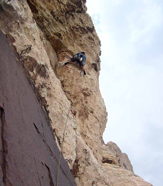 Launching onto the airy traverse of pitch 3.