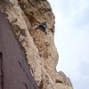 Launching onto the airy traverse of pitch 3.