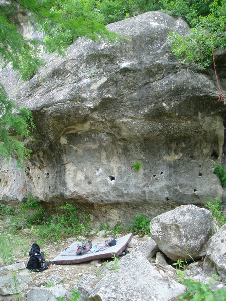 Climbs the line of pockets then crimps and slopers straight up from the pad shown. Notice the rope downclimb to the right.