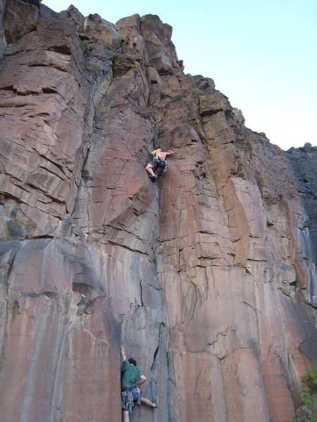 Pulling through the crux of <em>Blow Hole</em> and Brian Quiter starting up the "Unnamed (crack left of Blow Hole)." July 29, 2008.